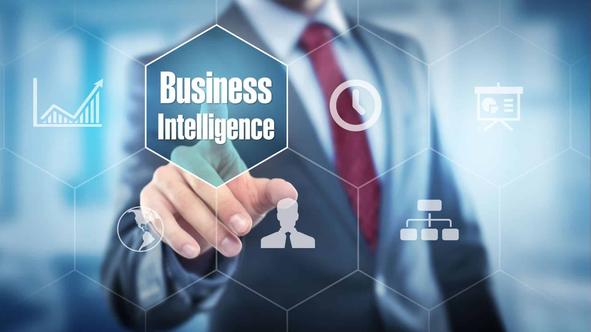 A person in a suit touches a transparent screen displaying the words Business Intelligence and various business-related icons.